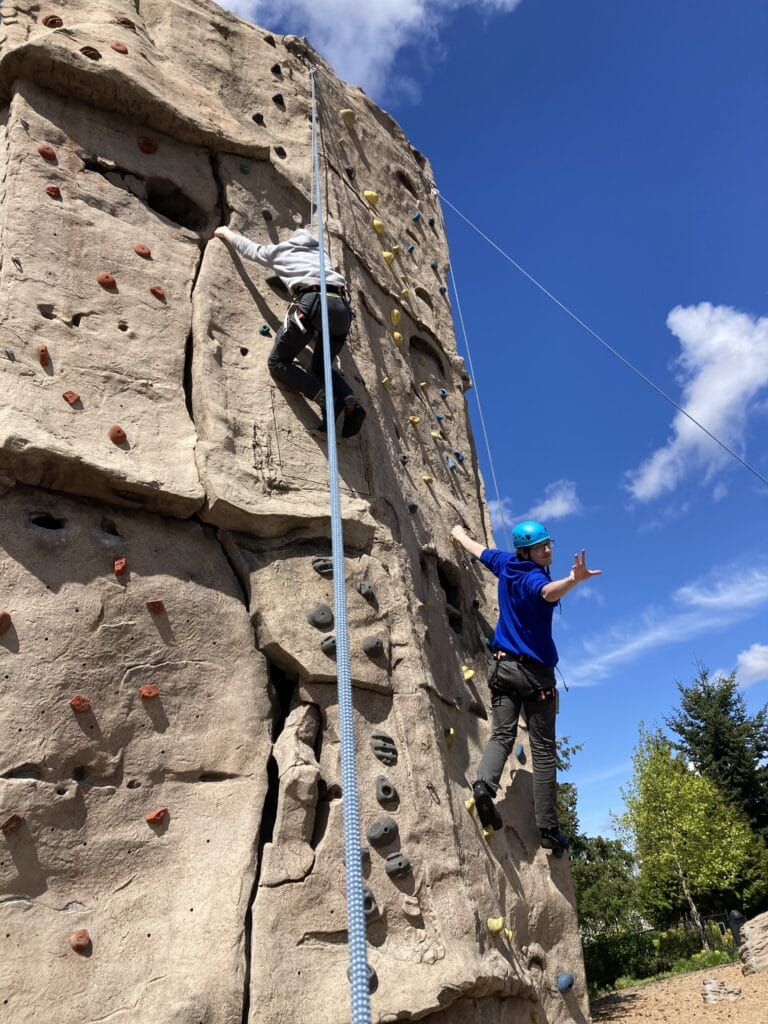 Students Climbing At Rock Wall